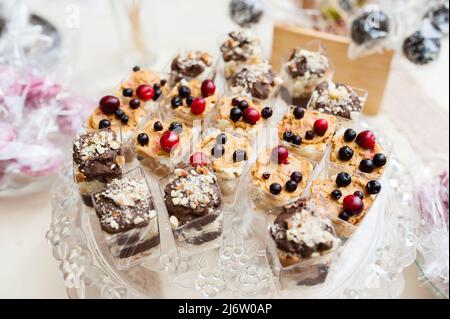 Multi-colored cakes and sweets on the festive table. Stock Photo