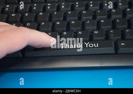 Black Computer Keyboard with Thank You text. Close-up of an electronic Computer Device part, keypad. Stock Photo