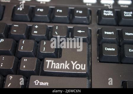 Black Computer Keyboard with Thank You text. Close-up of an electronic Computer Device part, keypad. Stock Photo