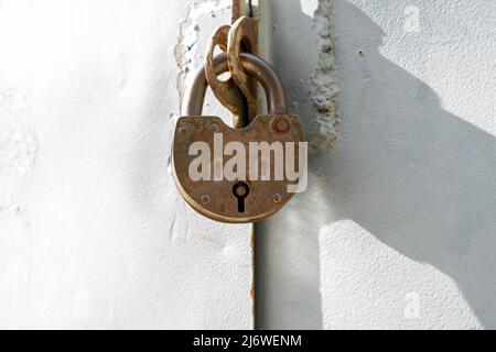 The metal doors are closed with a large old metal lock Stock Photo