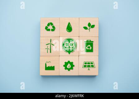 Net Zero and Carbon Neutral Concepts, Net zero and carbon neutral concept. Net zero greenhouse gas emissions target. wooden cube with green net center Stock Photo