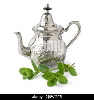 Moroccan teapot and twig of fresh mint isolated on white background Stock Photo