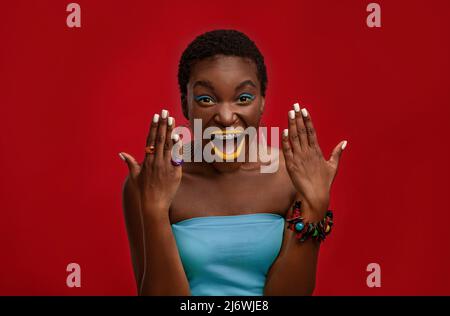 Emotional african american woman showing her manicure Stock Photo