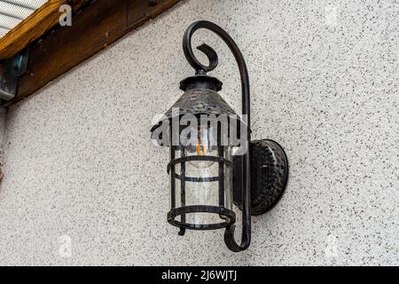 Lamp in vintage style. The lamp is attached to the wall. The lamp is black Stock Photo