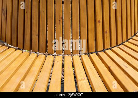 Bench with wooden boards close up. Background from wooden boards arranged in a semicircle. Wooden bench round Stock Photo