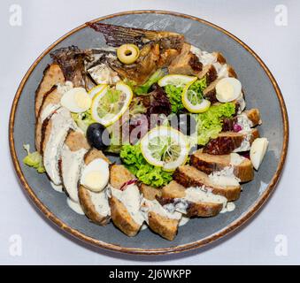 Stuffed carp. The fish is decorated with vegetables, fruits and quail eggs Stock Photo