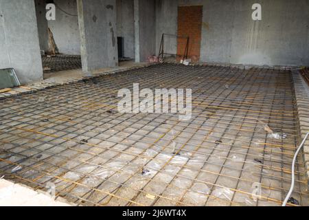 reinforced structure for self-leveling floor in a room of a monolithic building, selective focus Stock Photo