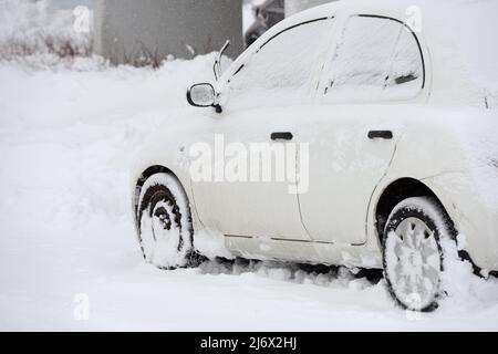car covered with snow after snowfall in Finland Stock Photo