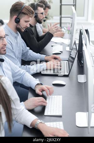 Call centre employees working on computers with their headset Stock Photo