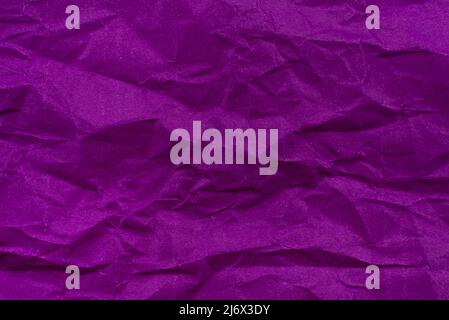 Background from crumpled paper in purple or lilac color. Paper texture with wrinkles and folds Stock Photo