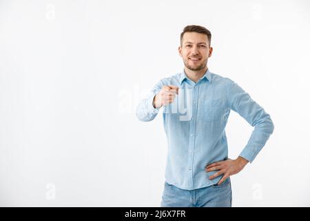A young man in a blue shirt gestures. Motivational poster, are you ready. Copy Space. Stock Photo