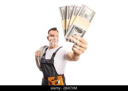 Electrician carrying cables on his shoulder and holding stacks of money isolated on white background Stock Photo