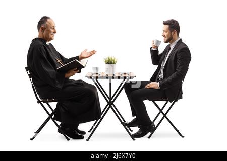 Priest talking to a businessman and sitting in a cafe isolated on white background Stock Photo