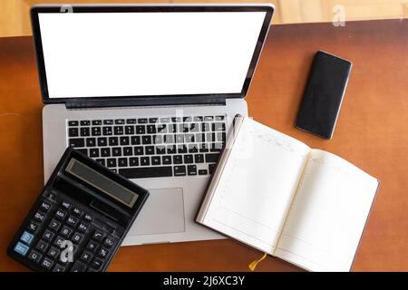 Workspace desk, calculator, Business image, Blank screen computer and supplies. laptop mock up screen view. work from home concept Stock Photo