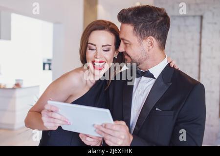 Happy young white couple shopping together by digital tablet and have fun Stock Photo