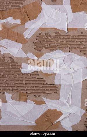 Abstract vertical background - a piece of corrugated packaging cardboard with pieces of self-adhesive tape glued on for design Stock Photo