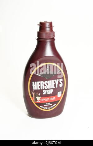 Plastic squeeze bottle of Hersey's chocolate syrup used for toppings on ice-cream or other desserts isolated on white background Stock Photo