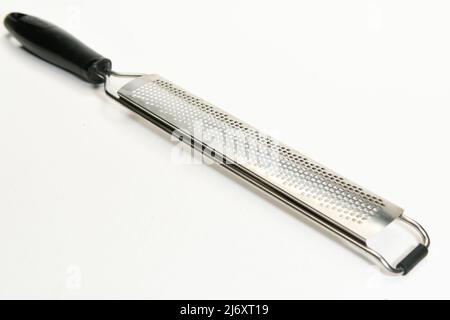 Zester used in food preparation for removing skin from citrus fruit isolated on white background Stock Photo
