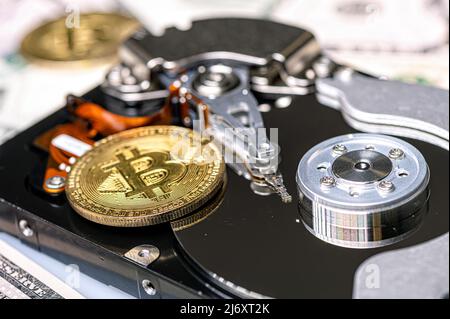 Bitcoin BTC coins, open hard drive and dollar bills, cryptocurrency and digital payment system Stock Photo