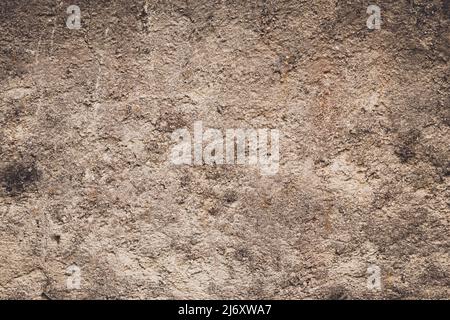 Closeup detail of old brown stucco clay wall, abstract rough surface background or grunge backdrop with vignette effect, architectural material Stock Photo