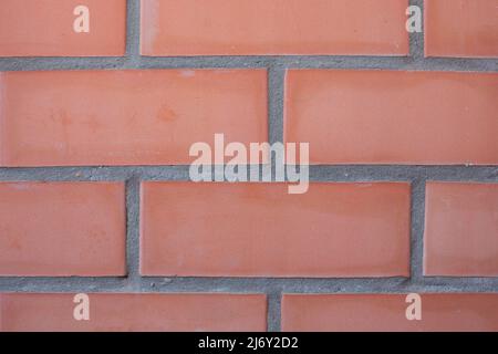 Brick wall made of facing bricks, close-up. Background for text. Stock Photo