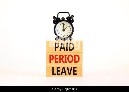 Paid period leave symbol. Concept words Paid period leave on wooden blocks. Black alarm clock. Beautiful white table white background. Business medica Stock Photo