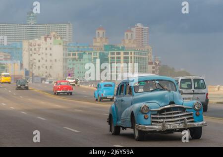 January 11, 2016 -- Havana, Cuba: Classic cars drive along the Malecon in Havana.  (Liz Roll) Stock Photo