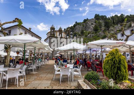 Grazalema, Cadiz, Spain - May 1, 2022: People eating an drinking in the bar terraces of Grazalema village, (Grazalema mountains), one of the villages Stock Photo