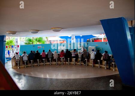 Rare indoor photo of people inside the famous Cuban ice cream parlor Coppelia, in Havana, Cuba eating ice cream. Stock Photo