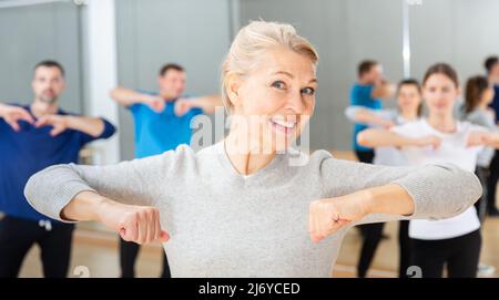 Mature woman practicing vigorous dance Stock Photo