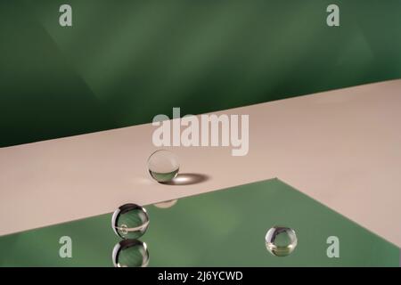Cosmetic background podium for product presentation. Showcase mock up for perfume advertising, cosmetics stand, branding scene with ball. Green Stock Photo