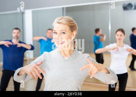 Mature woman practicing vigorous dance Stock Photo