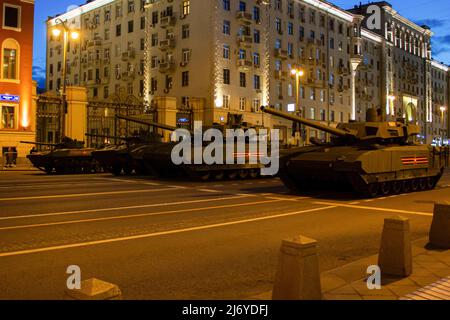 The T-14 Armata tanks seen in formations in front of the mayor's residence on Tverskaya street in Moscow. The final night rehearsal of the traditional Victory Day Parade is one of the main runs before the actual event scheduled for May 9. Besides its symbolic meaning, the yearly Victory Day Parade has been a tool to demonstrate Russia's new weaponry to potential adversaries. Stock Photo