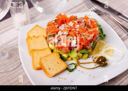 Salmon tartare with avocado and toasted bread Stock Photo