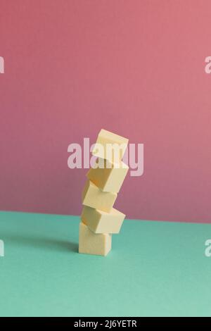 Stack of makeup sponge on mint green table. pink wall background Stock Photo