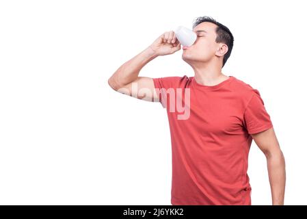 Guy drinking coffee from cup on white background Stock Photo