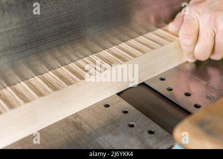 Faceless master working on woodworking planer in joinery Stock Photo