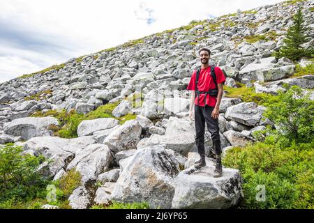 Portrait of a young man on the Granite mountain trail in the Washington Cascades. Stock Photo