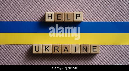 Help Ukraine text and Ukrainian flag closeup Stock Photo