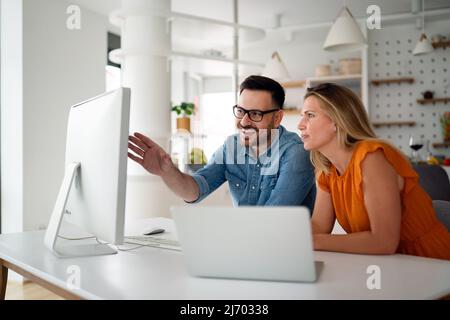 Programmers cooperating at IT company developing apps Stock Photo