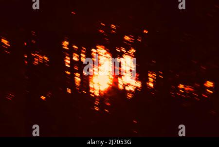 Abstract dark motion background with blurred red lights, bright spots. Long exposure. Stock Photo