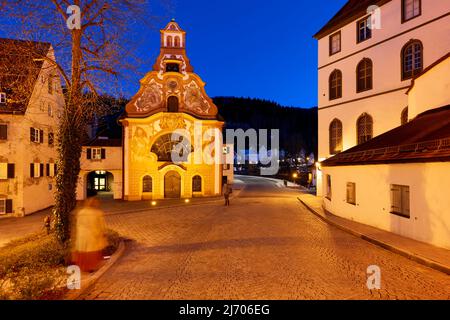 Germany Bavaria Romantic Road. Fussen. Heilig-Geist-Spitalkirche (Holy Spirit Hospital Church) and its rococo painted facade Stock Photo