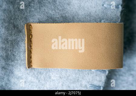 Leather blank label, brown patch on a blanket as mockup, space for text Stock Photo