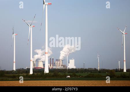 03 May 2022, North Rhine-Westphalia, Erkelenz: RWE wind turbines rotate at the Garzweiler open pit mine in front of the Neurath power plant. Photo: Oliver Berg/dpa Stock Photo