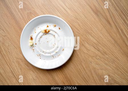 White ceramic dessert plate with pastry leftover, crumbs, top view Stock Photo