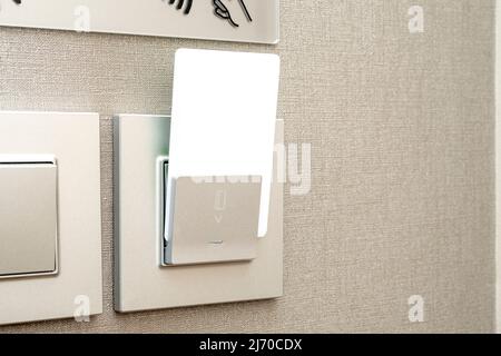 White plastic keycard, blank electronic key insert into box in hotel, space for text Stock Photo
