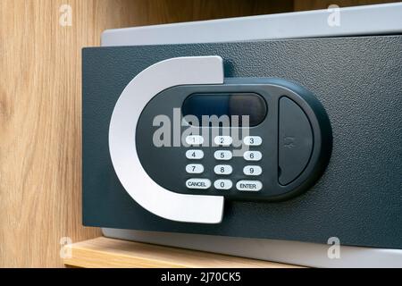 Close-up of code lock on opened iron safe door at hotel room Stock Photo