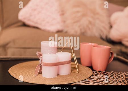 Lights and cups stand on the coffee table near the sofa. Stock Photo