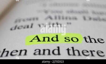 And so text in open book page, selective focus, close up, macro shot of English message, education idea and novel concept, sitting view Stock Photo