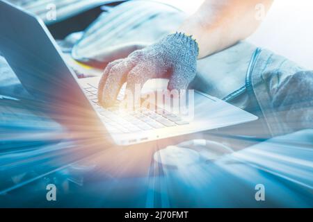 closeup technician mechanic male hand using laptop computer for setup software and hardware with machine. computer science and engineering concept. Stock Photo